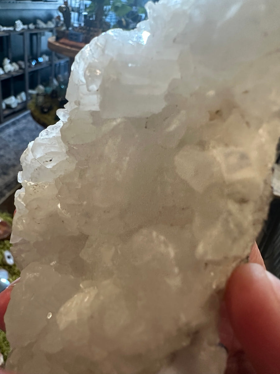 12.9 oz natural white Mexican crystal cluster shown in hand, front view