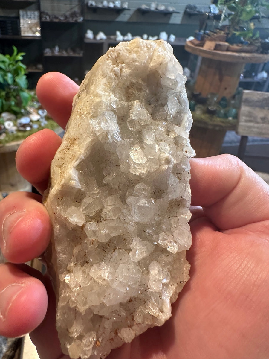 10.4 oz clear white crystal pocket from California Sierra Nevada foothills displayed lengthwise in hand