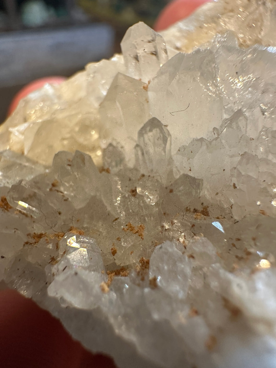 Full natural quartz-like clear and white crystal cluster in hand for scale