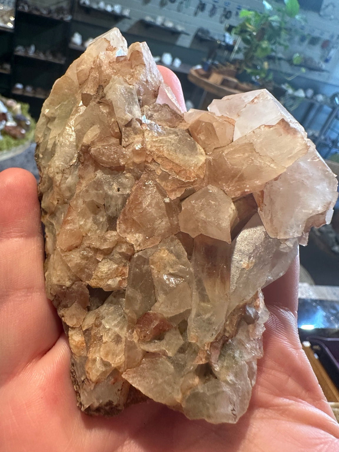 Close-up of earthy natural matrix with greenish translucent crystals and peach formations
