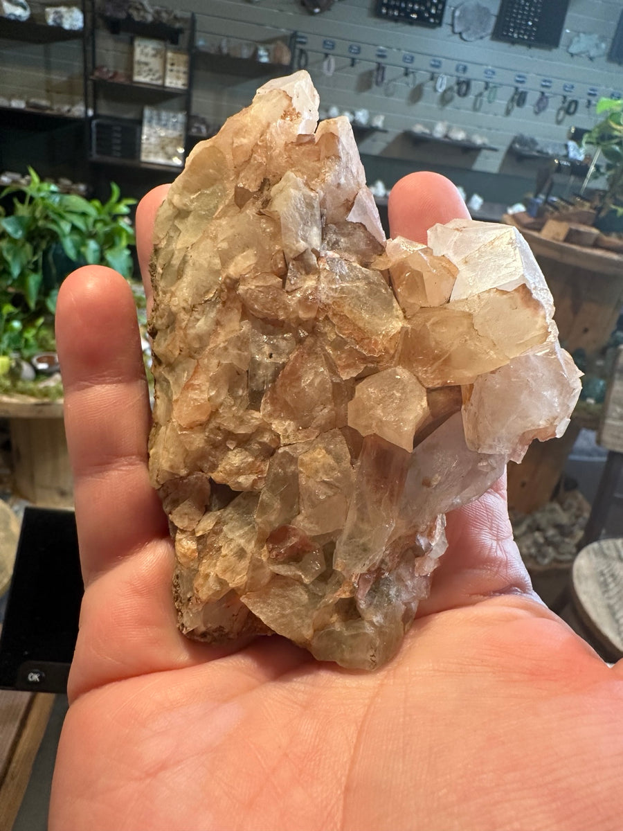 8 oz Mexican translucent crystal cluster with smoky green-gray and peach points, front view