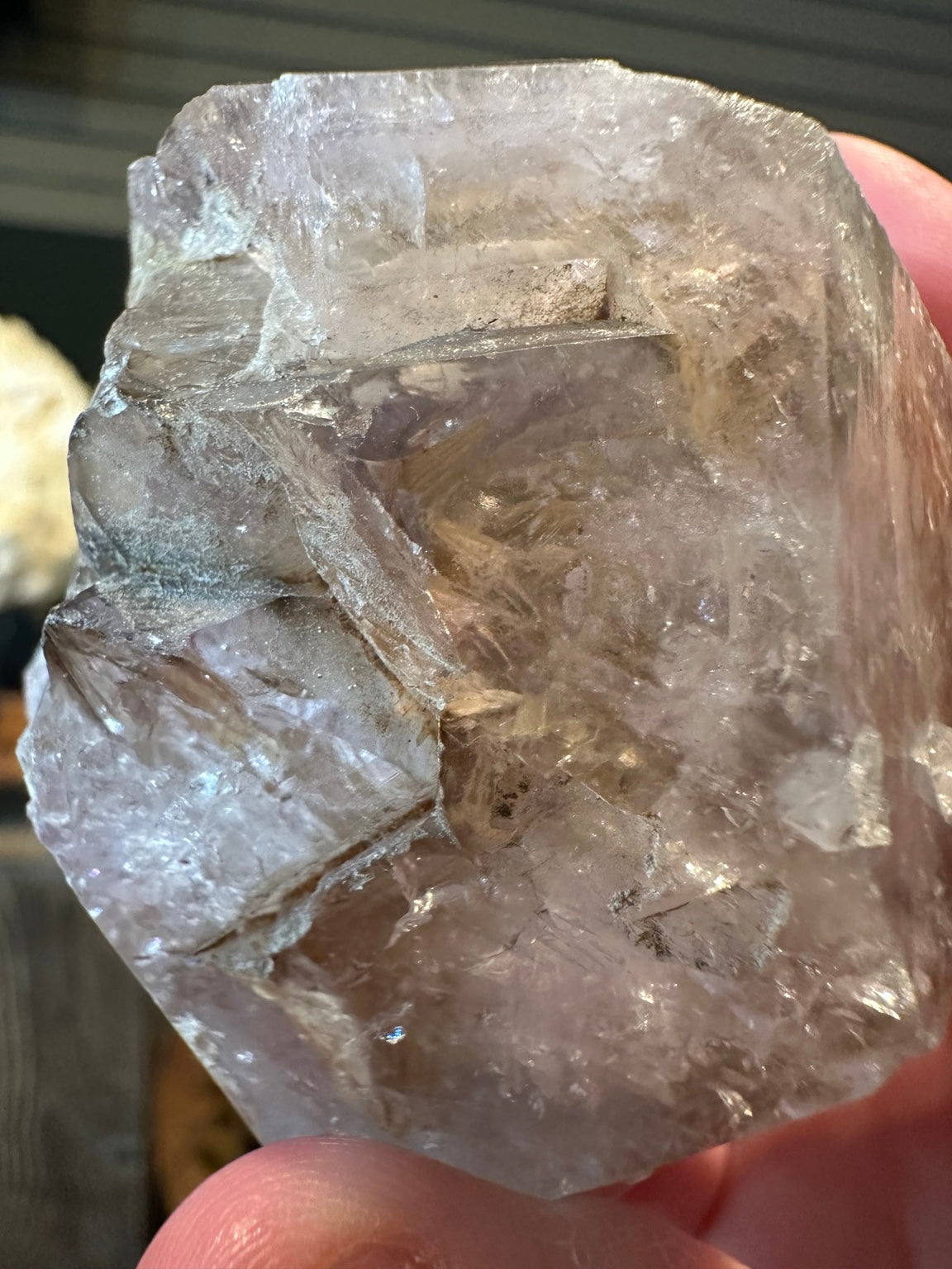 Natural intricate growth and small rainbow reflections within pale smoky quartz