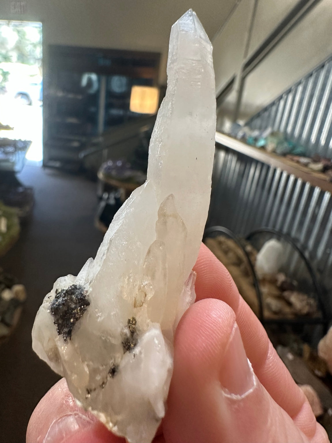 Brazil quartz crystal side view with metallic inclusions