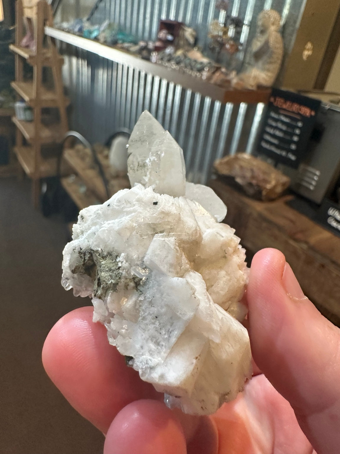 Brazilian quartz crystal cluster with white bladed crystal growth and green mineralization — view 4