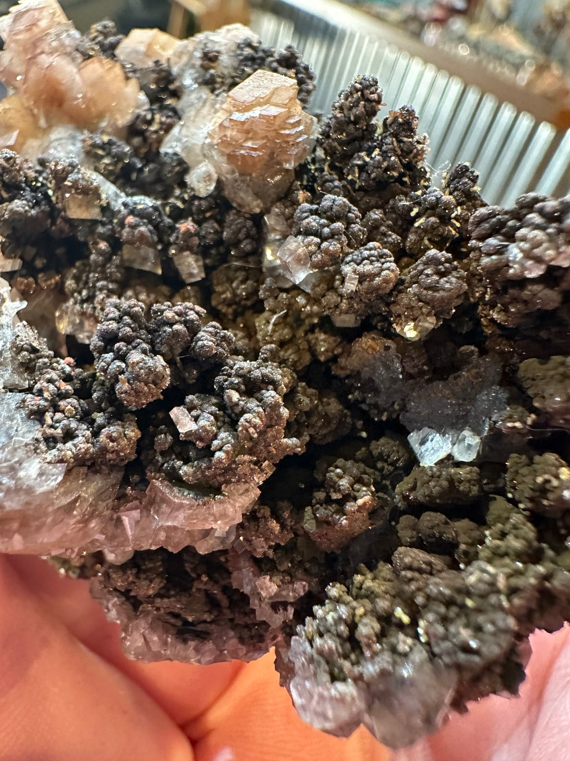 Pinkish calcite crystals on botryoidal iron oxide matrix