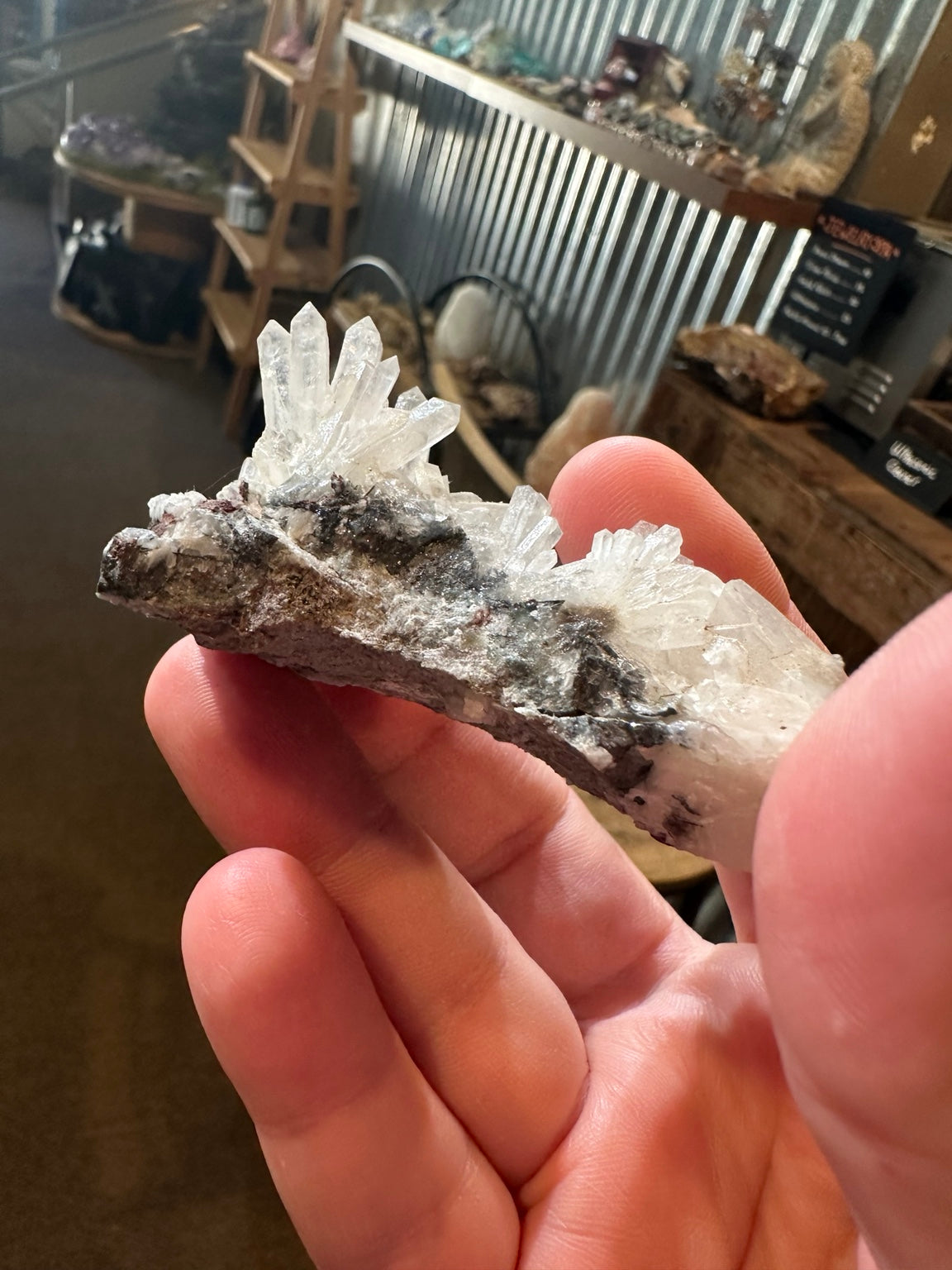 Radiating quartz crystal cluster with iron-stained natural matrix