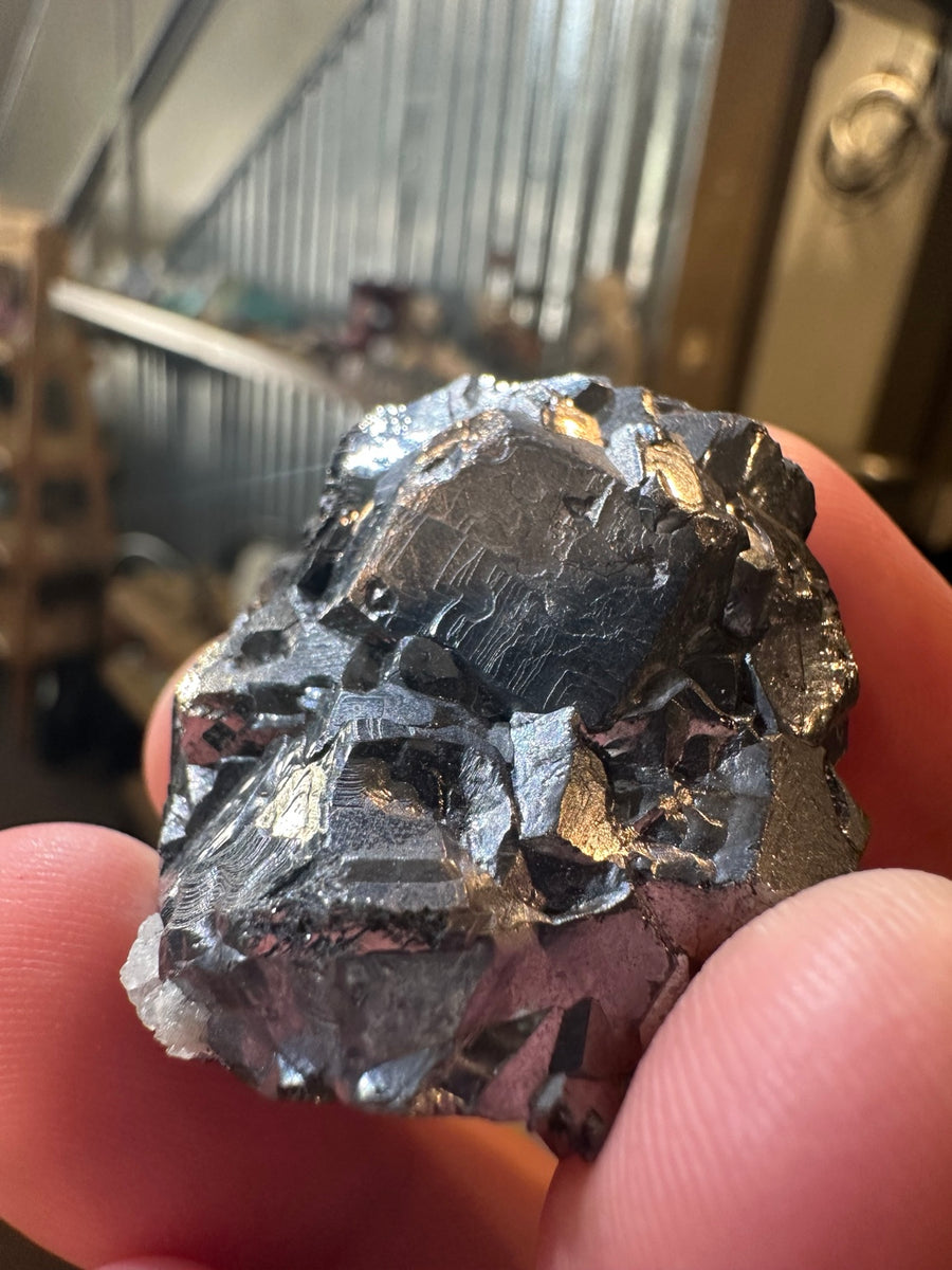 Metallic hematite crystal cluster with quartz from Nevada — view 1