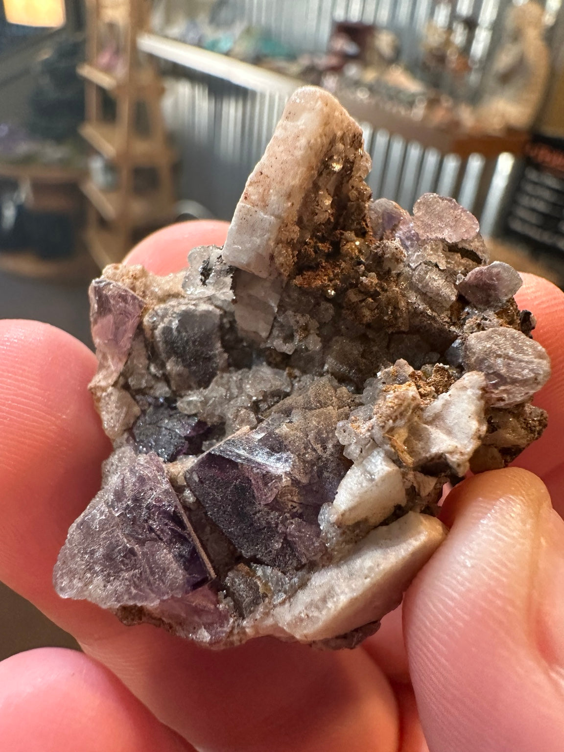 Purple fluorite crystal cluster on quartz-rich matrix from Mexico — view 1